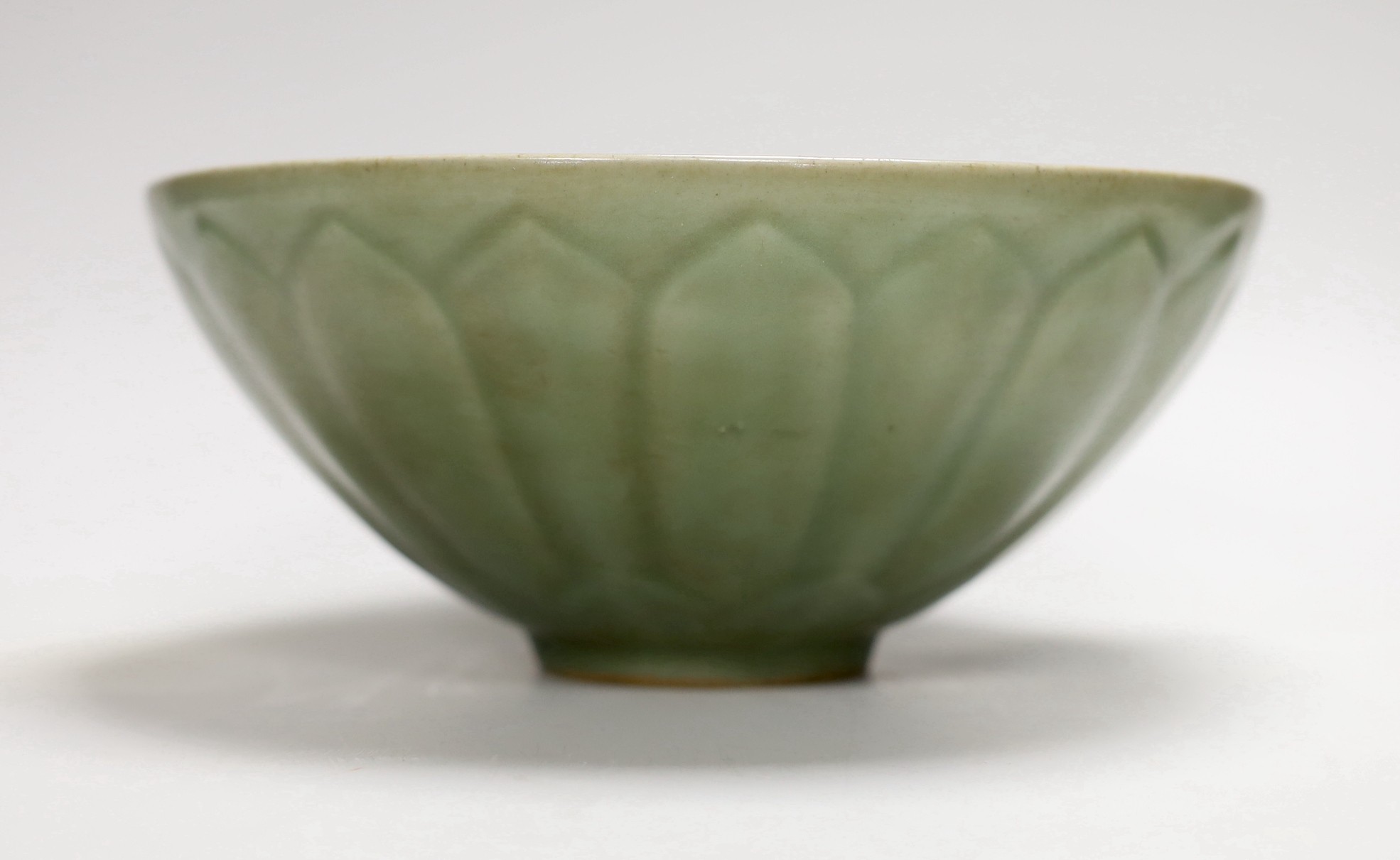A Chinese celadon ground ‘lotus’ bowl, 21cm diameter